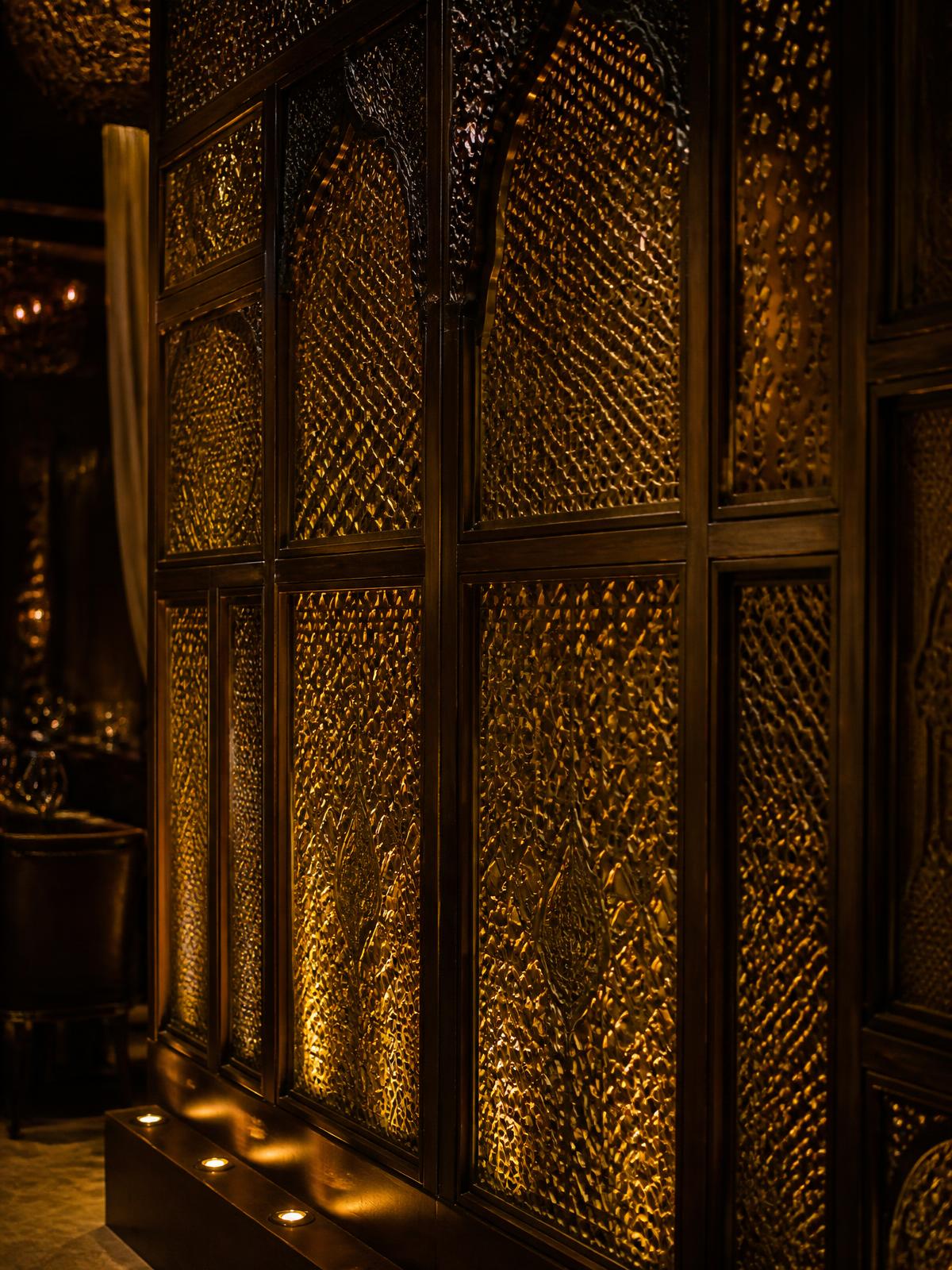 Carved brass screen wall detail